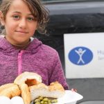 a child receiving food in turkey earthquake
